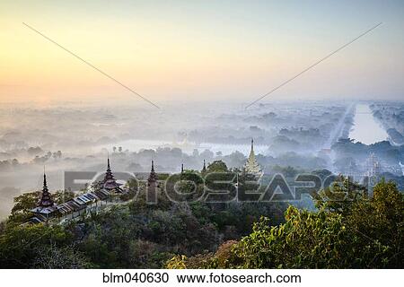 Stock Image - Aerial view of towers in misty landscape. Fotosearch