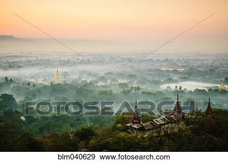 Stock Photo - Aerial view of towers in misty landscape. Fotosearch
