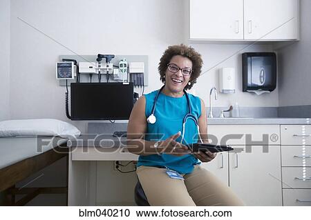 African American doctor holding digital tablet View Large Photo Image Stock Image - African American doctor holding digital tablet. Fotosearch