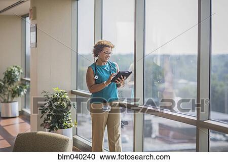 African American doctor using digital tablet View Large Photo Image Stock Image - African American doctor using digital tablet. Fotosearch