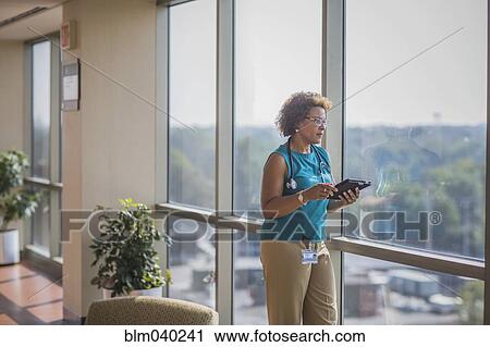 Stock Image - African American doctor using digital tablet. Fotosearch