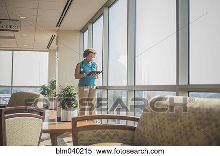 African American doctor using digital tablet at window View Large Photo Image Stock Photography - African American doctor using digital tablet at window. Fotosearch