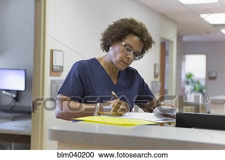 African American nurse writing in hospital View Large Photo Image Stock Image - African American nurse writing in hospital. Fotosearch