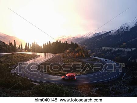 Stock Photography - Ambulance driving on winding remote road. Fotosearch