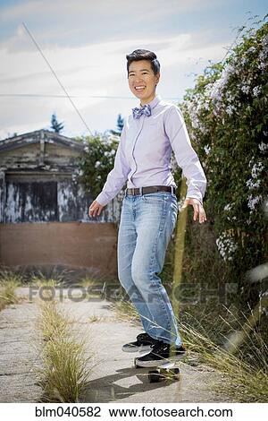 Androgynous woman riding skateboard View Large Photo Image Stock Image - Androgynous woman riding skateboard. Fotosearch