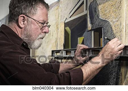 Picture - Caucasian artist drawing in studio. Fotosearch