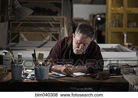 Stock Photo - Caucasian artist drawing in studio. Fotosearch