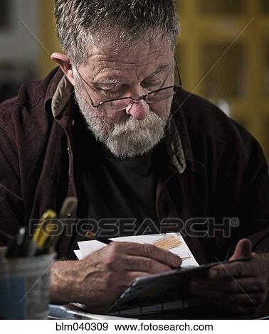 Stock Photo - Caucasian artist drawing in studio. Fotosearch
