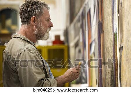 Stock Photography - Caucasian artist drawing in studio. Fotosearch