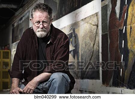 Stock Photo - Caucasian artist sitting in studio. Fotosearch