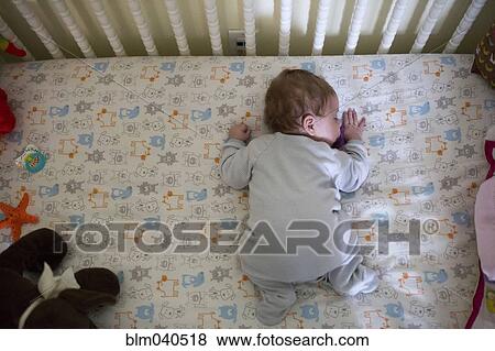 Caucasian baby girl sleeping in crib View Large Photo Image Stock Photo - Caucasian baby girl sleeping in crib. Fotosearch