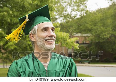 Stock Photo - Caucasian college graduate wearing cap and gown. Fotosearch