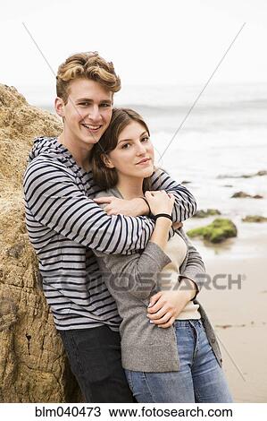 Caucasian couple hugging on beach View Large Photo Image Stock Image - Caucasian couple hugging on beach. Fotosearch