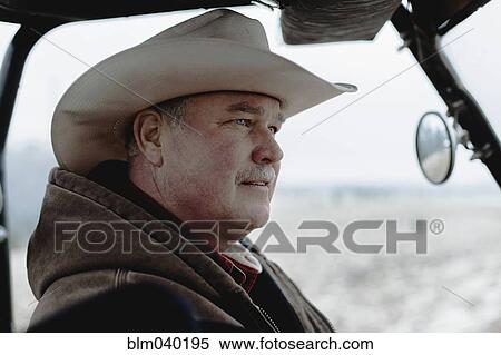 Caucasian farmer driving equipment in farm field View Large Photo Image Stock Photography - Caucasian farmer driving equipment in farm field. Fotosearch