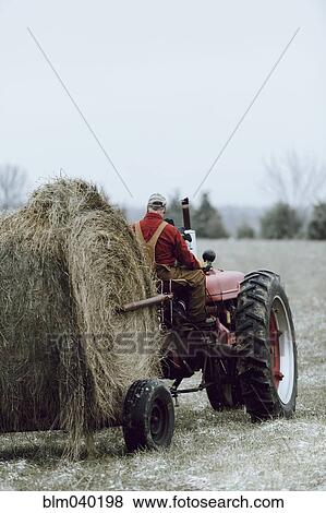 Caucasian farmer driving tractor in field View Large Photo Image Stock Photo - Caucasian farmer driving tractor in field. Fotosearch