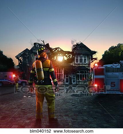 Caucasian firefighter at burned house View Large Photo Image Stock Image - Caucasian firefighter at burned house. Fotosearch