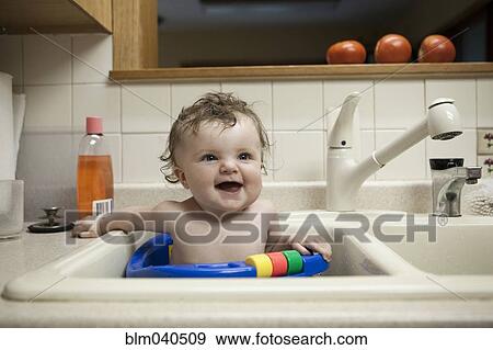 Caucasian girl bathing in kitchen sink View Large Photo Image Stock Photo - Caucasian girl bathing in kitchen sink. Fotosearch
