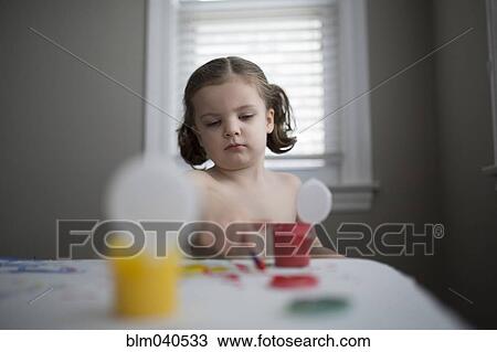 Stock Image - Caucasian girl finger painting. Fotosearch