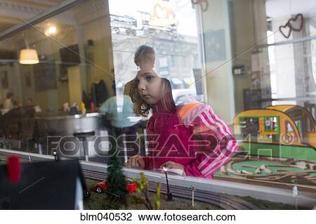 Caucasian girl looking in window View Large Photo Image Stock Image - Caucasian girl looking in window. Fotosearch