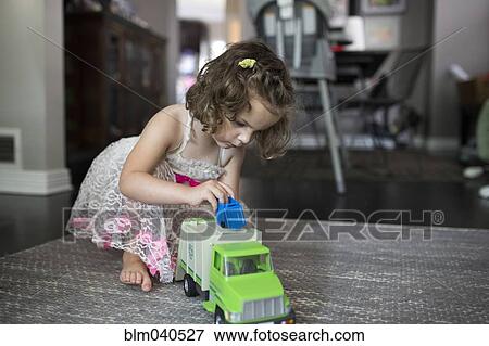 Caucasian girl playing in living room View Large Photo Image Stock Photo - Caucasian girl playing in living room. Fotosearch