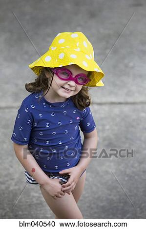 Caucasian girl wearing goggles and sun hat View Large Photo Image Stock Image - Caucasian girl wearing goggles and sun hat. Fotosearch