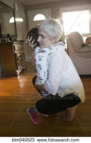 Caucasian grandmother and granddaughter hugging View Large Photo Image Stock Image - Caucasian grandmother and granddaughter hugging. Fotosearch