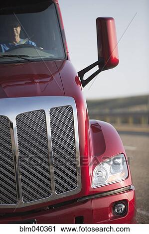 Stock Image - Caucasian man driving truck on highway. Fotosearch