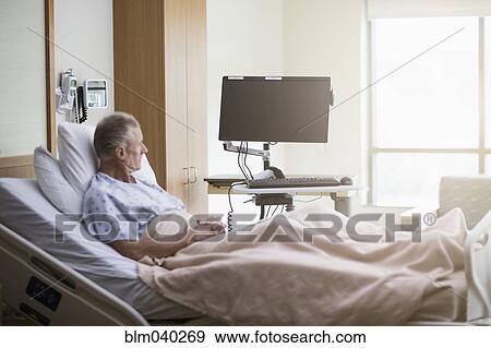 Stock Photo - Caucasian patient sitting in hospital bed. Fotosearch