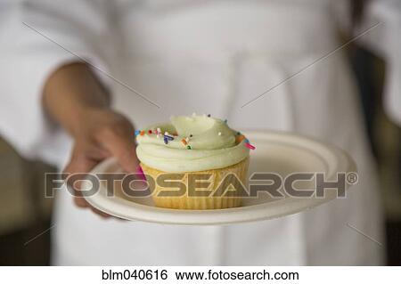 Chef carrying plate of cupcake View Large Photo Image Stock Photograph - Chef carrying plate of cupcake. Fotosearch