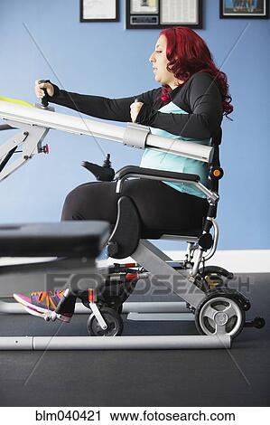Stock Image - Disabled woman doing physical therapy. Fotosearch
