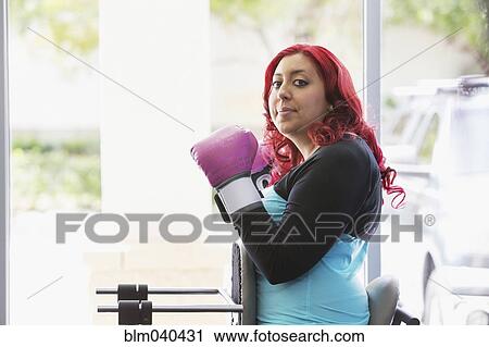 Stock Image - Disabled woman doing physical therapy with trainer. Fotosearch
