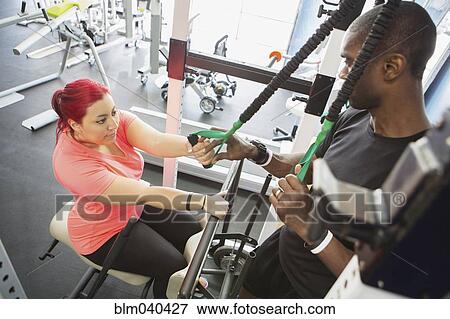 Disabled woman doing physical therapy with trainer View Large Photo Image Stock Photo - Disabled woman doing physical therapy with trainer. Fotosearch