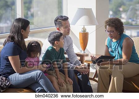 Stock Photograph - Doctor and patients using digital tablet. Fotosearch