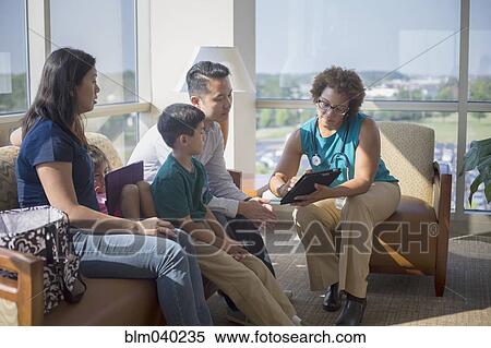 Stock Photography - Doctor and patients using digital tablet. Fotosearch