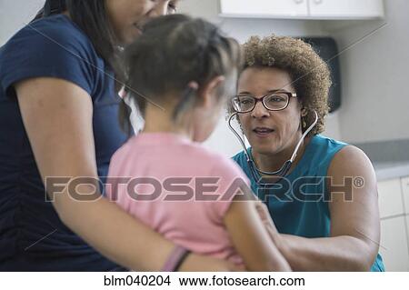 Picture - Doctor listening to chest of girl. Fotosearch