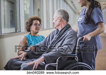Doctor talking to patient in wheelchair View Large Photo Image Stock Photo - Doctor talking to patient in wheelchair. Fotosearch