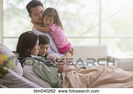 Family admiring newborn baby in hospital room View Large Photo Image Stock Image - Family admiring newborn baby in hospital room. Fotosearch