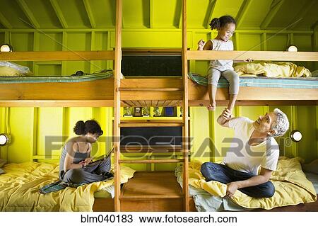 Father and daughters relaxing at camp View Large Photo Image Stock Image - Father and daughters relaxing at camp. Fotosearch
