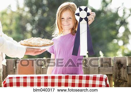 Stock Photo - Girl winning pie baking contest. Fotosearch