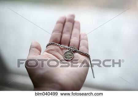 Hand of Caucasian woman holding necklace View Large Photo Image Stock Photo - Hand of Caucasian woman holding necklace. Fotosearch