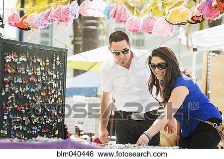 Hispanic couple shopping in outdoor market View Large Photo Image Stock Photograph - Hispanic couple shopping in outdoor market. Fotosearch