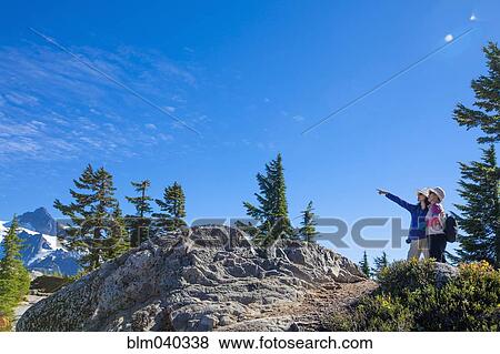 Stock Photo - Japanese mother and daughter admiring mountain. Fotosearch