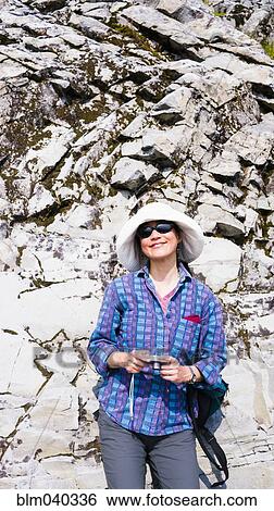 Stock Photograph - Japanese tourist photographing rock formation. Fotosearch
