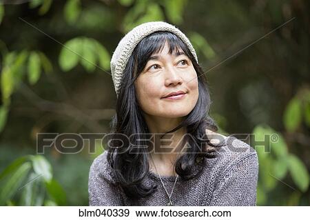 Stock Photo - Japanese woman in garden. Fotosearch