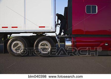 Stock Photo - Man checking truck cables. Fotosearch