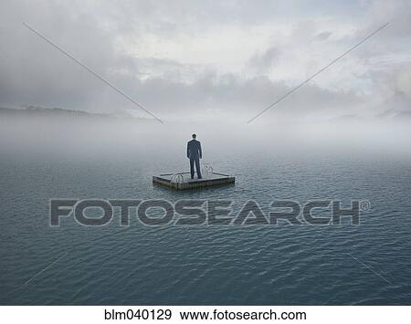 Man floating on dock in remote lake View Large Photo Image Stock Photo - Man floating on dock in remote lake. Fotosearch
