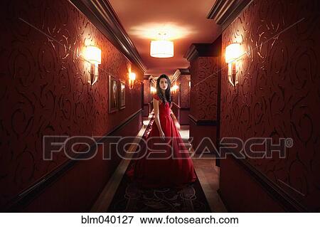 Middle Eastern woman wearing evening gown in hallway View Large Photo Image Stock Photo - Middle Eastern woman wearing evening gown in hallway. Fotosearch