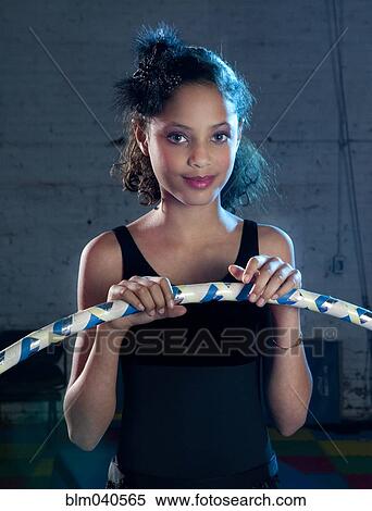 Stock Photography - Mixed race girl holding plastic hoop. Fotosearch