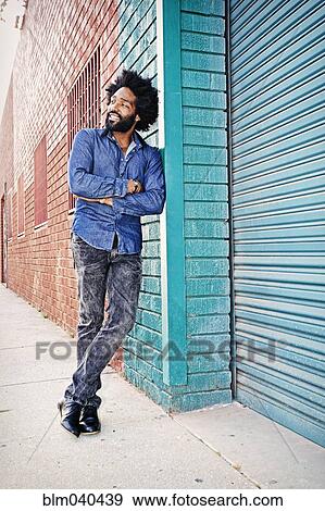Stock Photo - Mixed race man smiling outdoors. Fotosearch