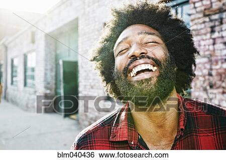 Stock Photograph - Mixed race man smiling outdoors. Fotosearch